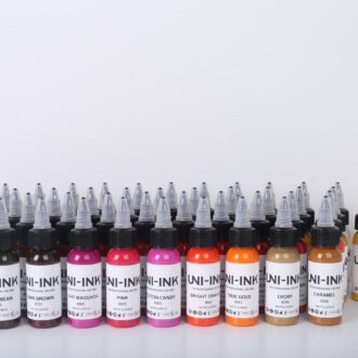 Uni-Ink professional tattoo ink bottles in multiple colours including pink, orange, brown, gold and magenta arranged in a row.